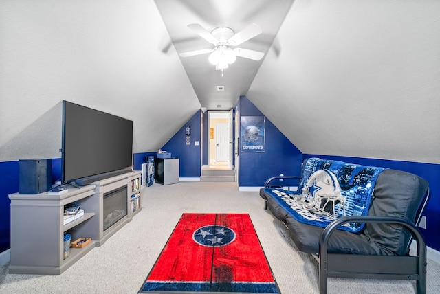 living room featuring ceiling fan, light colored carpet, and vaulted ceiling