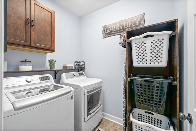 laundry room featuring light tile patterned floors, cabinets, and independent washer and dryer