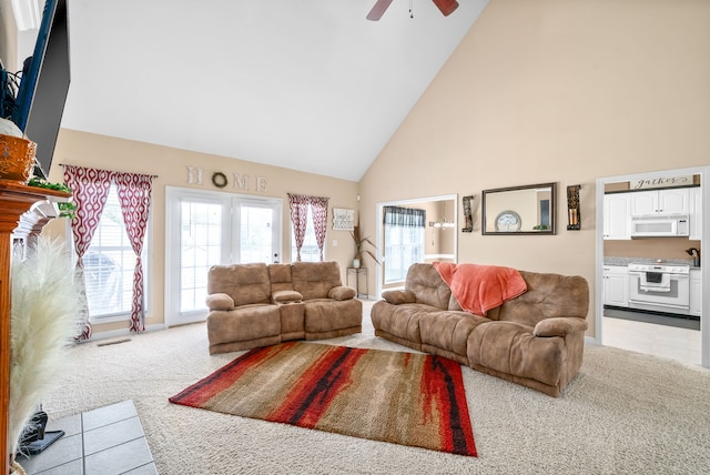 carpeted living room featuring ceiling fan and high vaulted ceiling