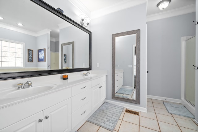 bathroom featuring tile patterned floors, a shower with door, vanity, and crown molding