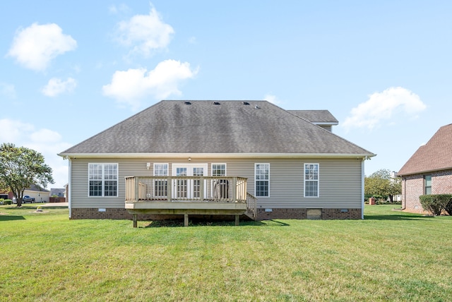 back of property with a lawn and a wooden deck