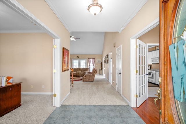 corridor featuring crown molding, lofted ceiling, and light carpet