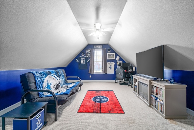 living room with a textured ceiling, carpet, lofted ceiling, and ceiling fan