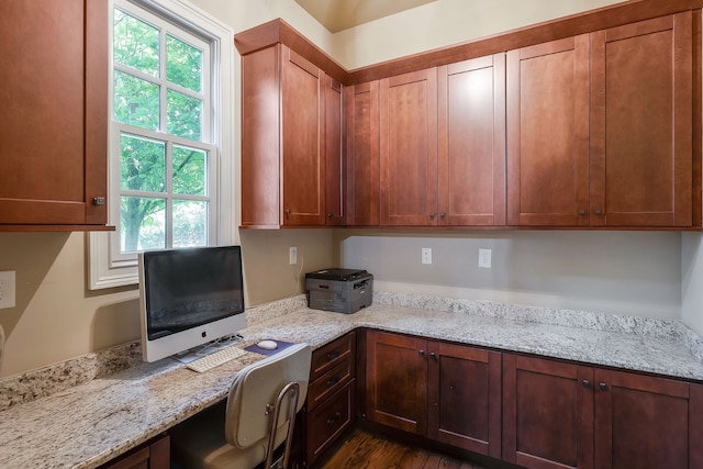 interior space featuring built in desk and dark wood-type flooring