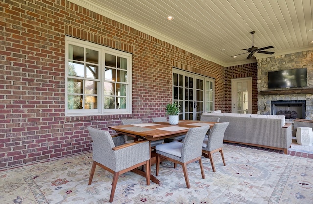 view of patio / terrace with ceiling fan and a stone fireplace