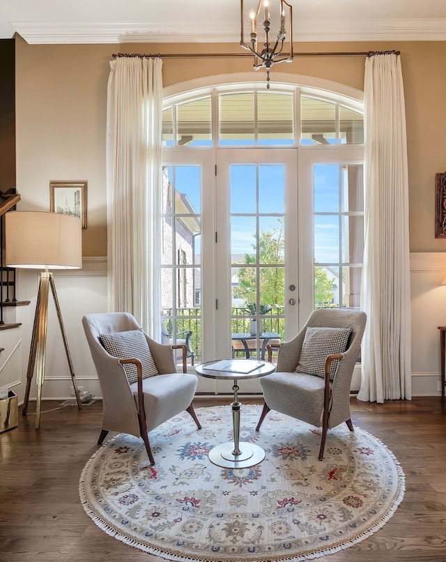 sitting room with ornamental molding, dark hardwood / wood-style floors, and french doors