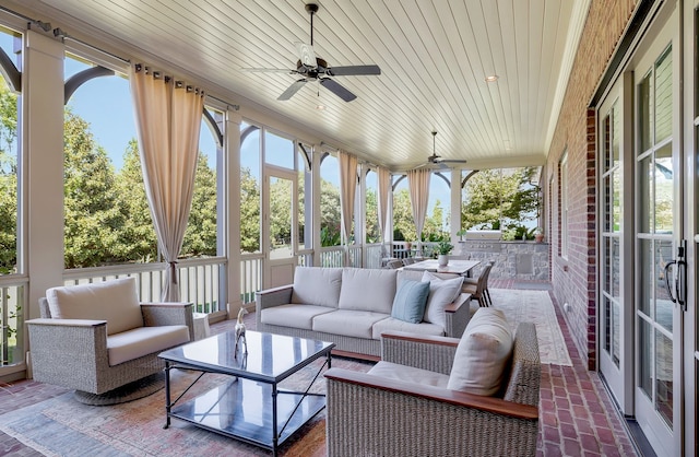 sunroom with ceiling fan and wood ceiling