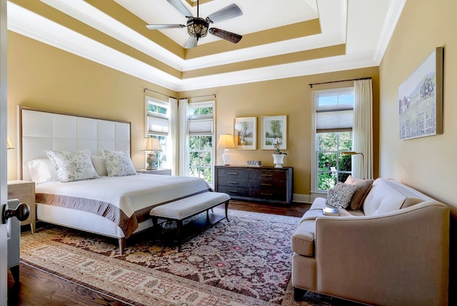 bedroom with ceiling fan, dark hardwood / wood-style floors, ornamental molding, and multiple windows