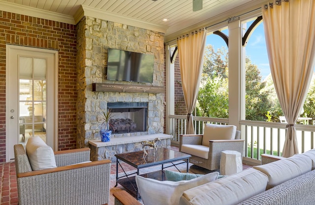 sunroom / solarium with plenty of natural light and a fireplace