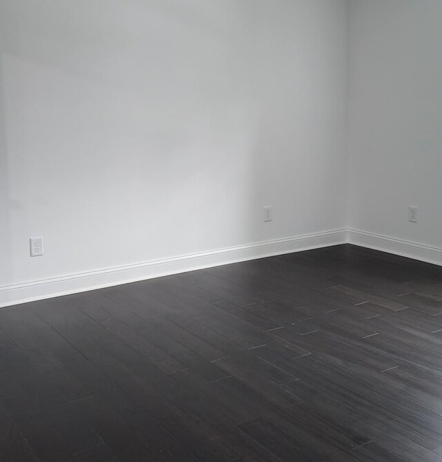 spare room featuring dark hardwood / wood-style flooring