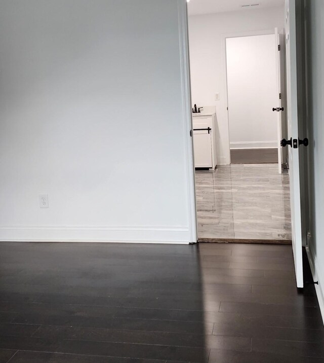 interior space with dark hardwood / wood-style flooring and sink