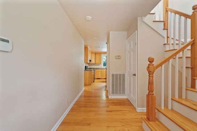 corridor featuring light hardwood / wood-style floors