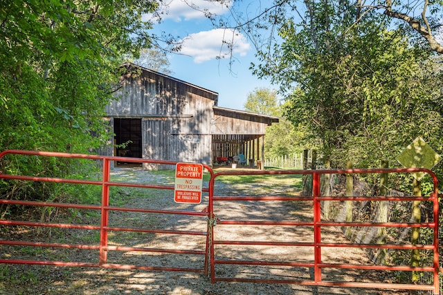 view of gate featuring an outdoor structure