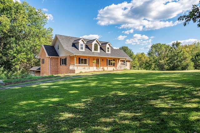 cape cod-style house with covered porch and a front yard