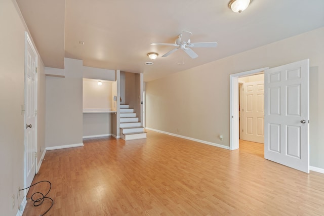 empty room featuring light wood-type flooring and ceiling fan