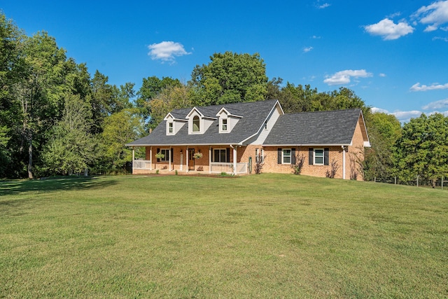 cape cod house featuring a front lawn and a porch