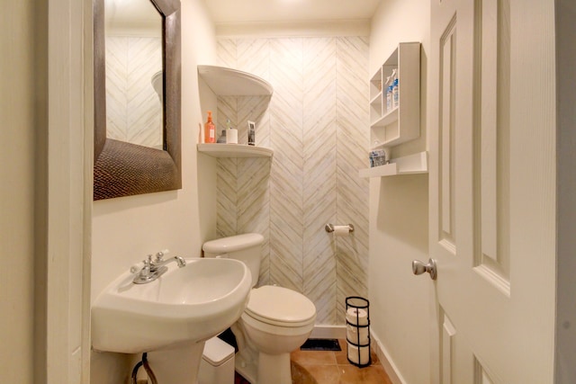 bathroom with tile patterned flooring, toilet, and sink