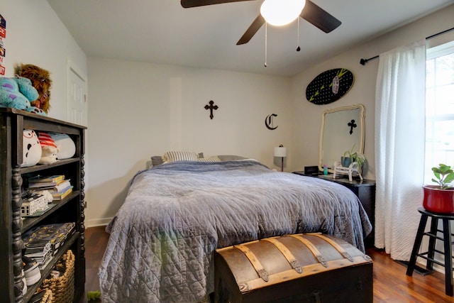 bedroom with dark hardwood / wood-style floors and ceiling fan