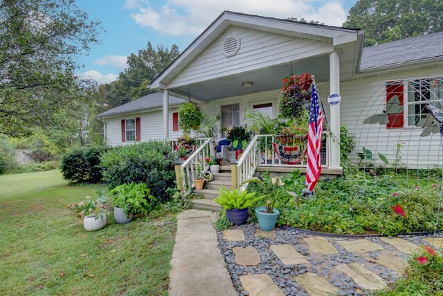 view of front of home with covered porch and a front yard