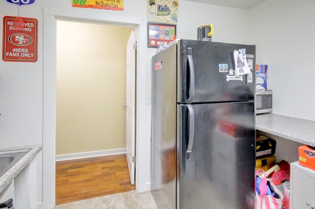 kitchen with light wood-type flooring and refrigerator