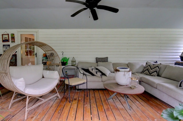 living room featuring wood-type flooring and ceiling fan