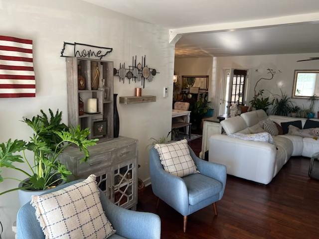 living room with dark hardwood / wood-style flooring, plenty of natural light, and ceiling fan