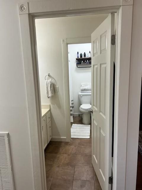 bathroom with vanity and toilet