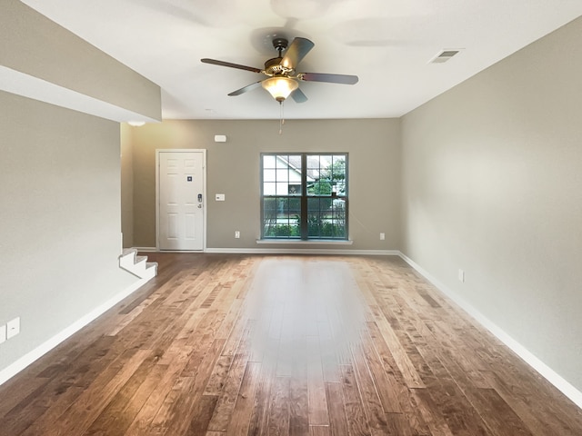 empty room with hardwood / wood-style floors and ceiling fan