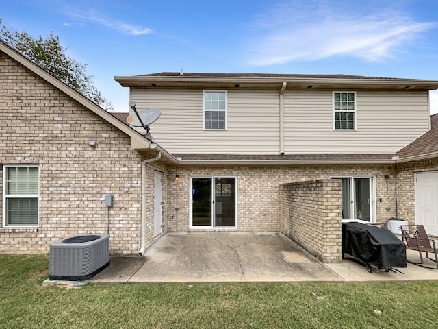 rear view of property featuring a lawn, a patio area, and central air condition unit