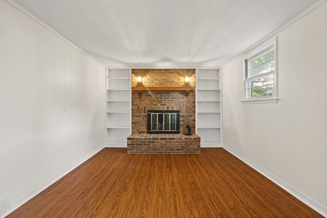 314 Robin Rd, Bowling Green, KY 42101 - unfurnished living room featuring wood finished floors, baseboards, built in shelves, and a brick fireplace