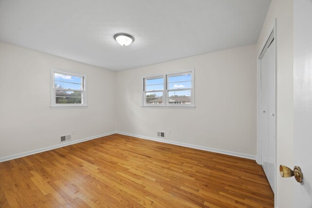 314 Robin Rd, Bowling Green, KY 42101 - unfurnished bedroom with light wood-style flooring, a closet, baseboards, and visible vents