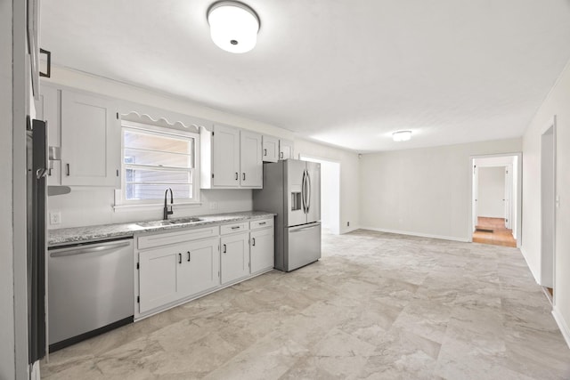314 Robin Rd, Bowling Green, KY 42101 - kitchen with baseboards, light stone counters, appliances with stainless steel finishes, marble finish floor, and a sink