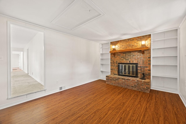 314 Robin Rd, Bowling Green, KY 42101 - unfurnished living room featuring baseboards, built in features, a brick fireplace, visible vents, and wood finished floors