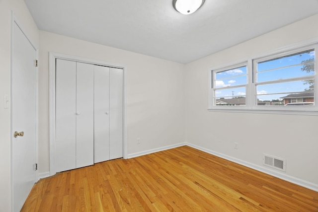 314 Robin Rd, Bowling Green, KY 42101 - unfurnished bedroom featuring a closet, light wood finished floors, baseboards, and visible vents