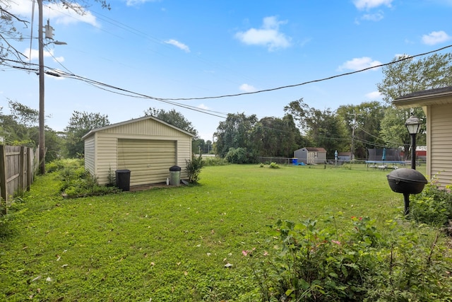 314 Robin Rd, Bowling Green, KY 42101 - view of yard featuring an outdoor structure, fence, a trampoline, and a garage