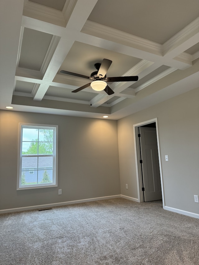 carpeted spare room featuring coffered ceiling, ornamental molding, and beamed ceiling