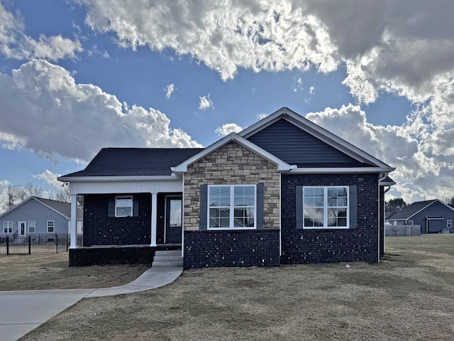 104 Thacker Dr, Portland, TN 37148 - view of front of property featuring stone siding, covered porch, and fence