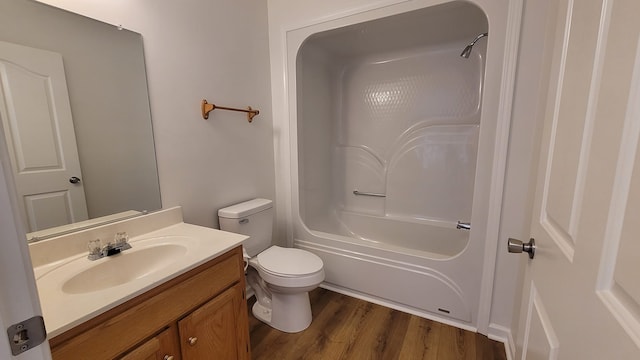 full bathroom featuring bathing tub / shower combination, hardwood / wood-style floors, vanity, and toilet