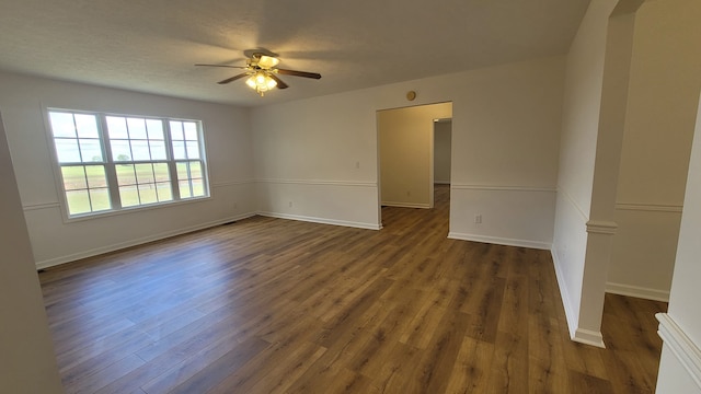 unfurnished room with dark hardwood / wood-style floors, a textured ceiling, and ceiling fan