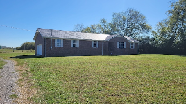 single story home featuring a garage and a front yard