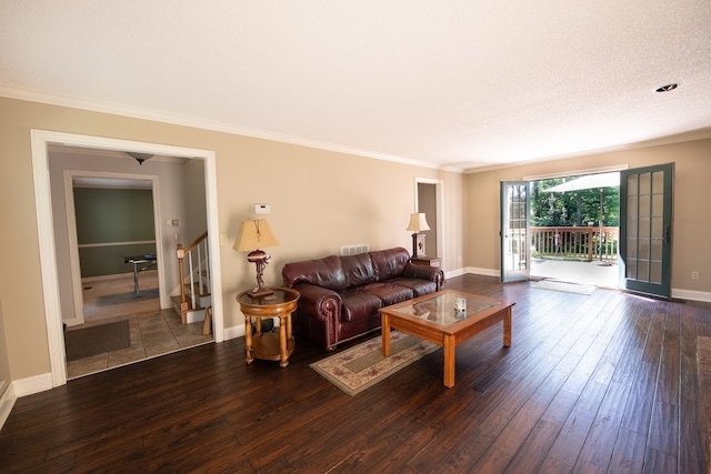 living room with a textured ceiling, ornamental molding, and dark hardwood / wood-style flooring