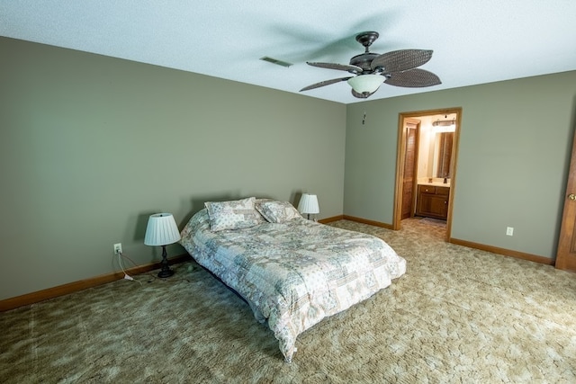 bedroom with a textured ceiling, carpet, ceiling fan, and ensuite bathroom