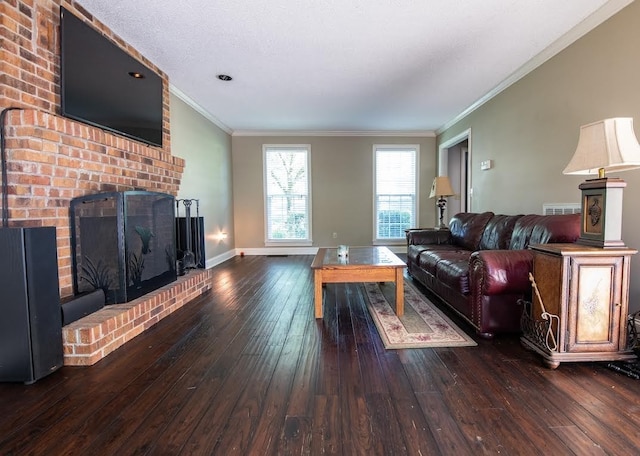 living room with crown molding, dark wood-type flooring, and a brick fireplace