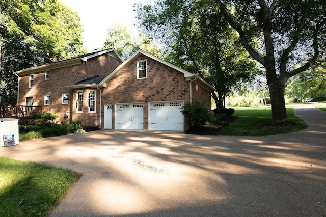 exterior space featuring a front lawn and a garage