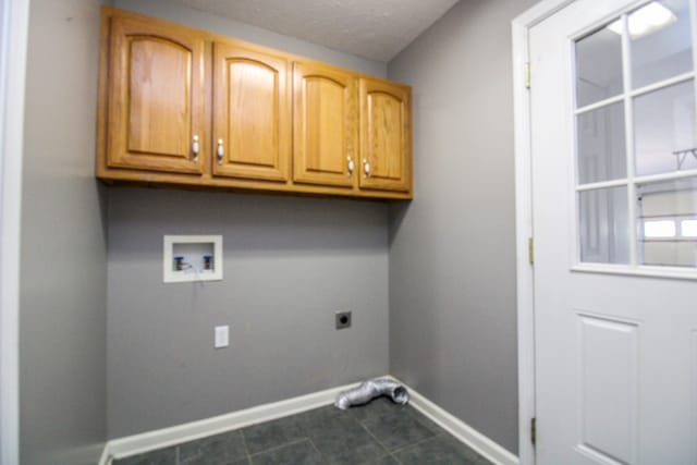 clothes washing area featuring washer hookup, electric dryer hookup, and cabinets