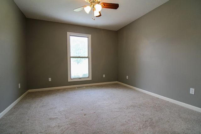 carpeted spare room featuring ceiling fan