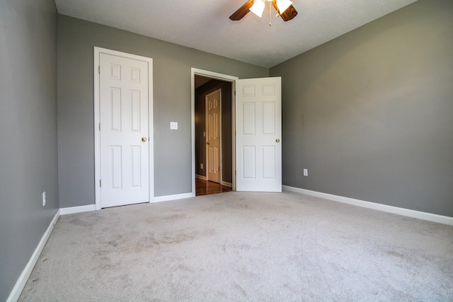 unfurnished bedroom with carpet flooring and ceiling fan