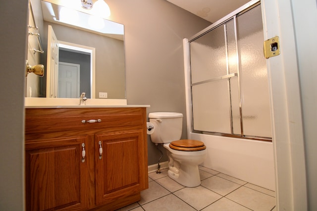 full bathroom featuring bath / shower combo with glass door, vanity, toilet, and tile patterned floors