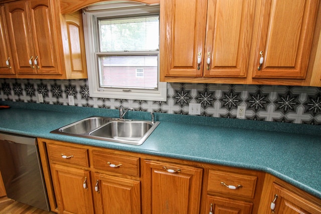 kitchen with hardwood / wood-style flooring, sink, tasteful backsplash, and stainless steel dishwasher