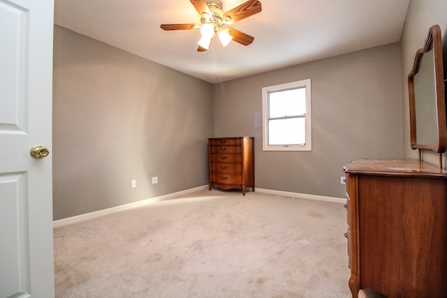 unfurnished bedroom with ceiling fan and light colored carpet